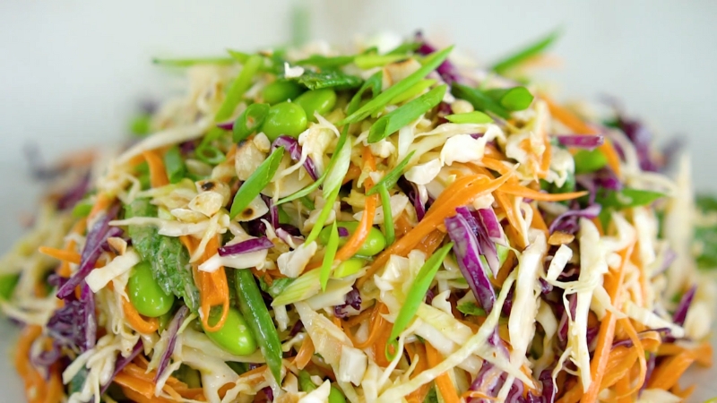 A Colorful Asian Red Cabbage Salad with Shredded Cabbage, Julienned Carrots, Edamame, and Sliced Green Onions