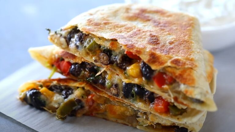 Layers of crispy quesadilla, bursting with black beans, corn, peppers, and cheese