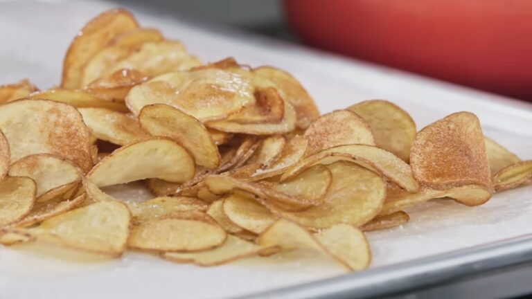 Crispy Homemade Potato Chips on A Parchment-Lined Tray