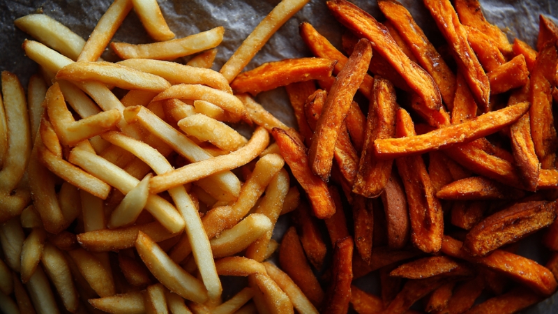 Crispy French fries and sweet potato fries side by side