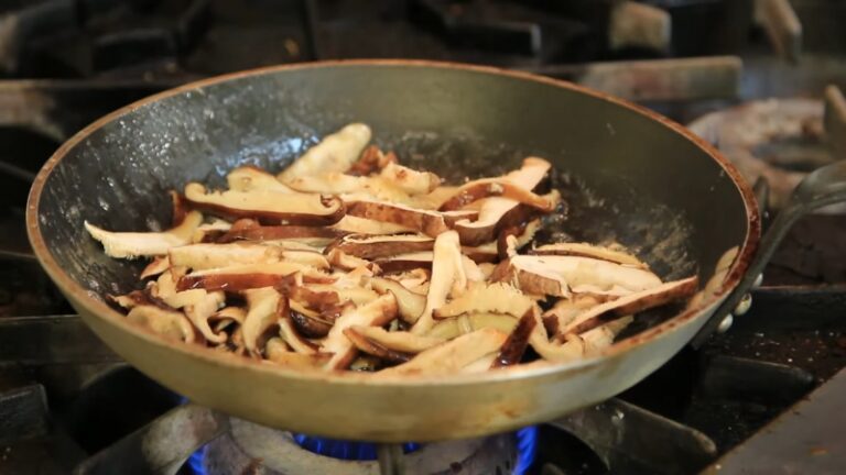 Shiitake mushrooms sauté in a hot pan with enough space to brown evenly without steaming