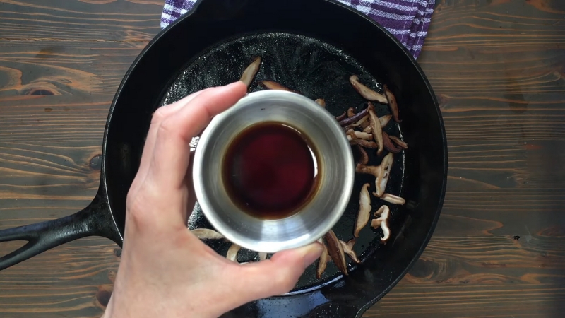 Soy sauce waits above browned shiitake mushrooms before late addition to keep texture firm