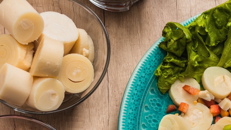Sliced hearts of palm on a plate and in a bowl, ready for simple prep and seasoning